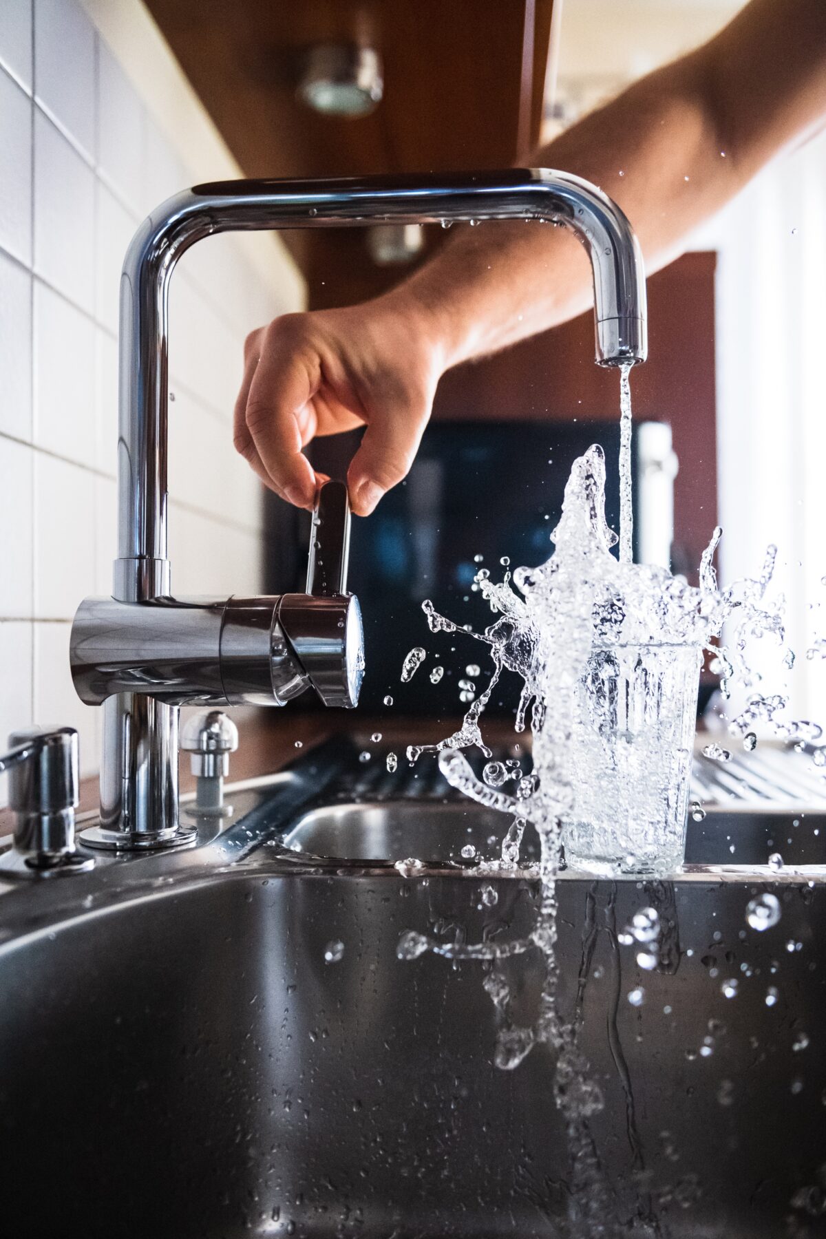 an image of a Broken faucet with water pouring out onto sink