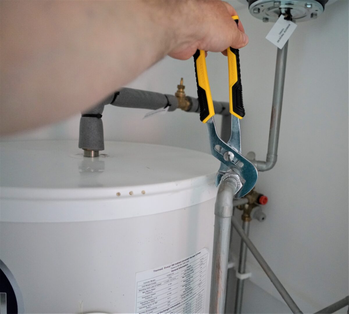 A plumber fixing a pipe in a bathroom