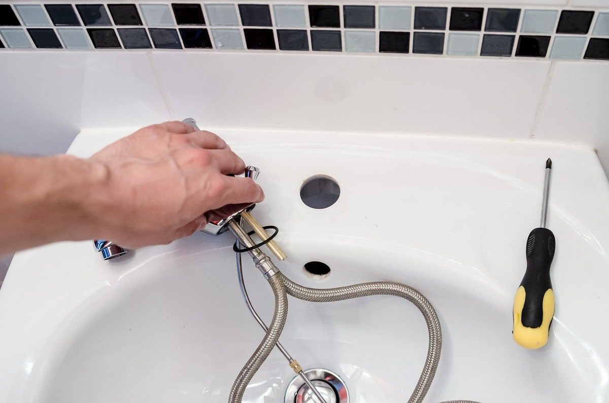 hand holding plumbing services tools