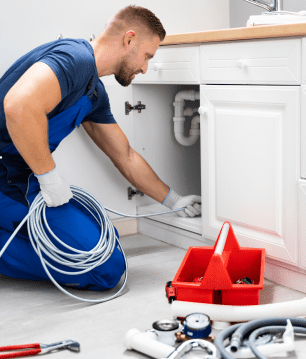 plumber performing a clogged drain repair and cleaning of a cloged kitchen sink. plumber performing a clogged drain repair and cleaning of a cloged kitchen sink.