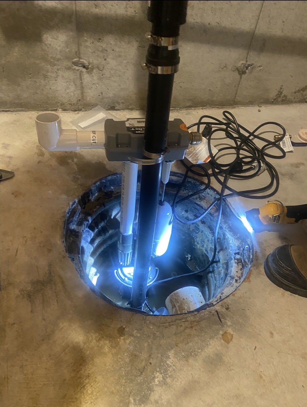 Close up mage of a plumber's hand repairing clogged drain using a tool.